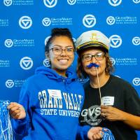 Two alumni pose for a photo